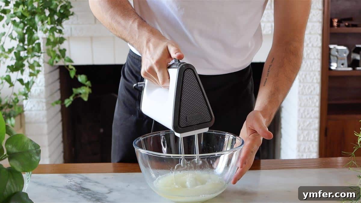 Decadent Chocolate Brownie Cake 10 Beating aquafaba and sugar with an electric hand mixer until the mixture becomes foamy and thick