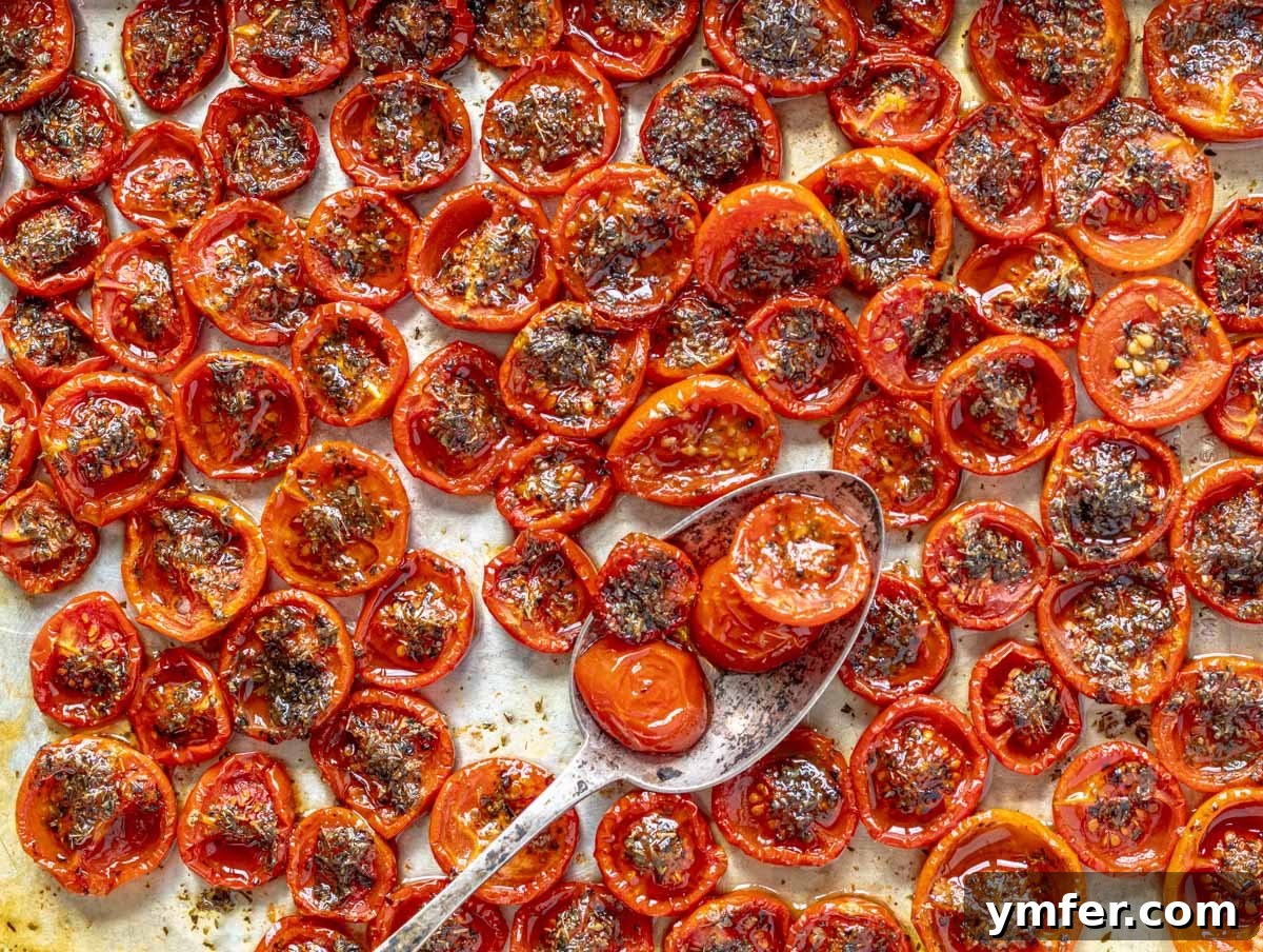 Slow-Roasted Tomato Jewels 3 confit tomatoes on a silver trey with a spoon