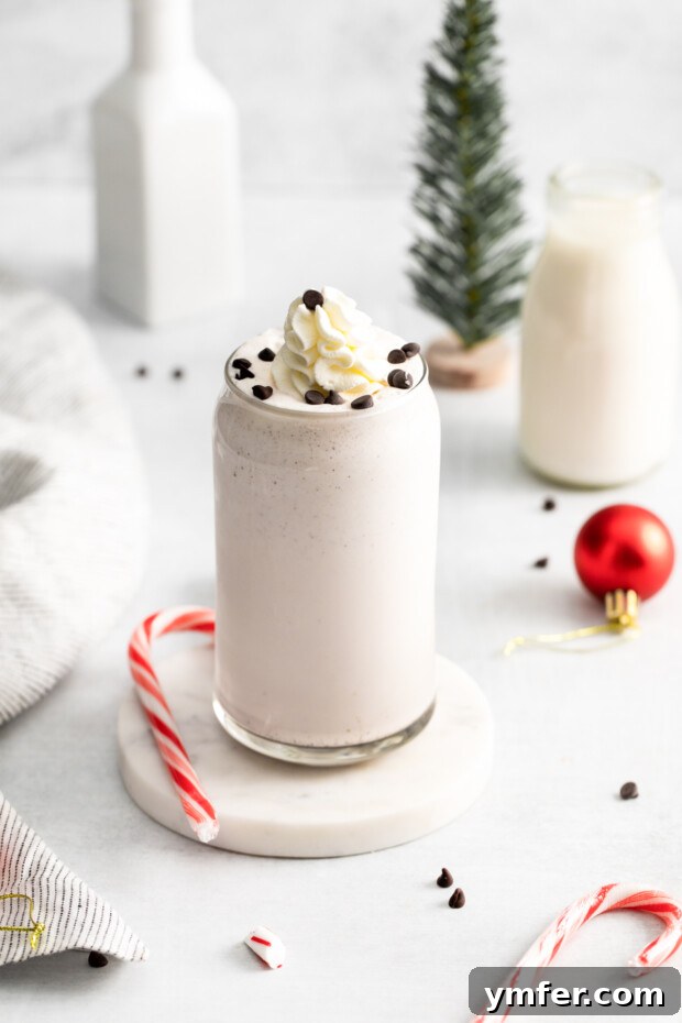 Candy Cane Crunch Milkshake 7 Peppermint Bark Milkshake sitting on a coaster.