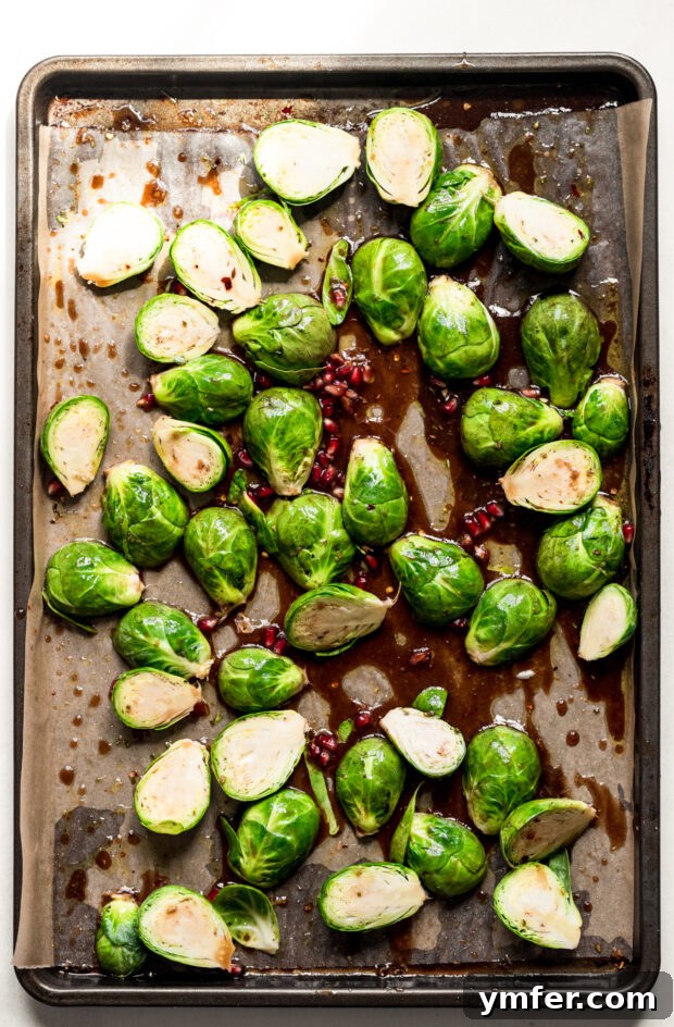 Simple Sheet Pan Marinated Salmon Dinner 4 Halved Brussels sprouts evenly spread on a sheet pan, ready for roasting.