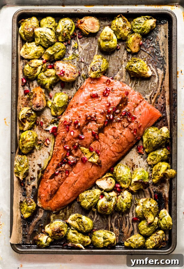 Simple Sheet Pan Marinated Salmon Dinner 5 Marinated salmon fillet placed alongside roasted Brussels sprouts on a sheet pan, baking to perfection.