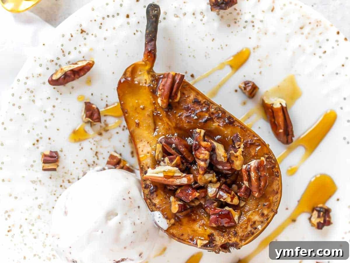 Half a baked pear on a plate with nuts and ice cream, ready to enjoy.