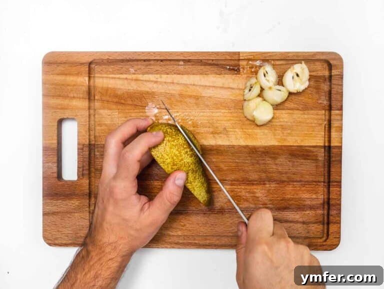 Slivering off the bottom of the pears to create a flat base.