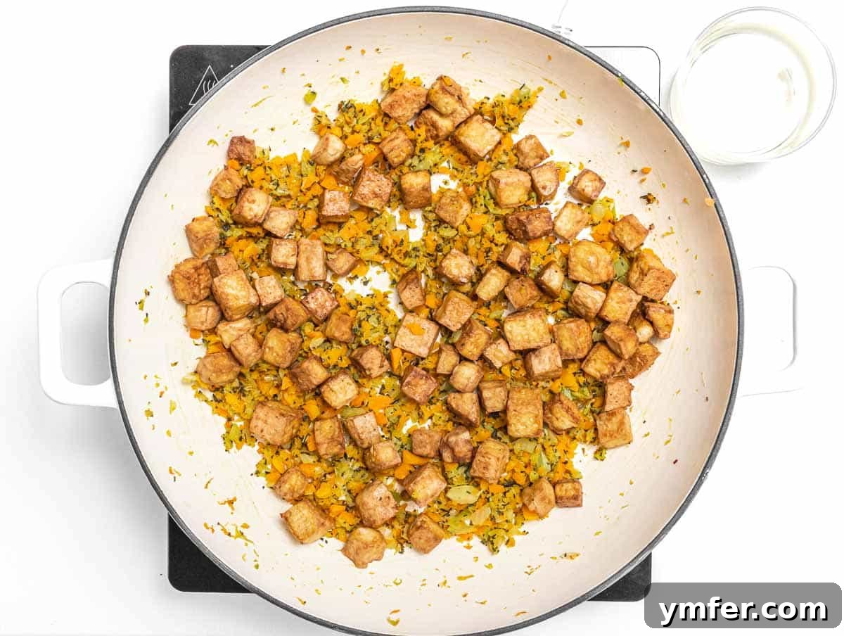 The Forager's Tofu Cacciatore 13 Baked tofu cubes added to the aromatic flavor base in a skillet, ready for the wine to be added.