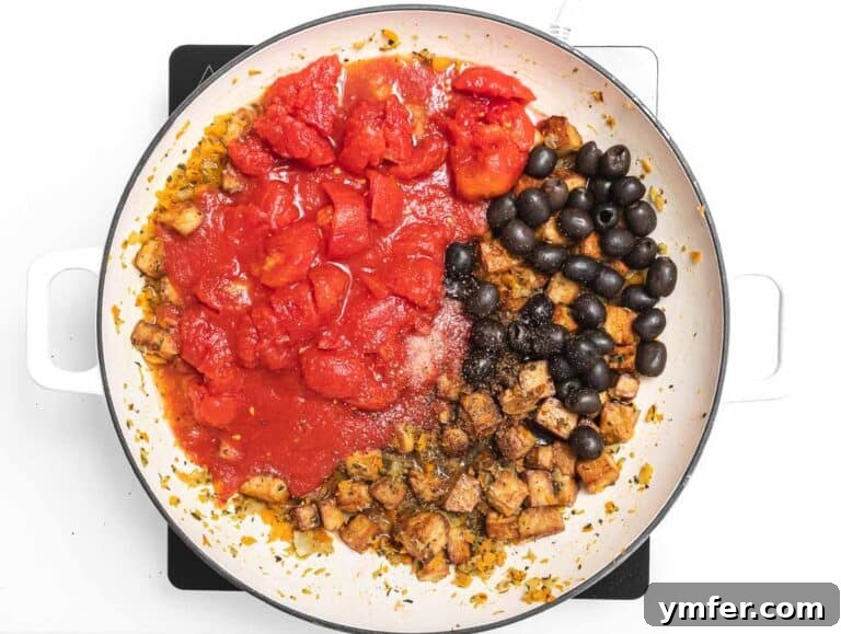 Add tofu, olives and tomato to the skillet