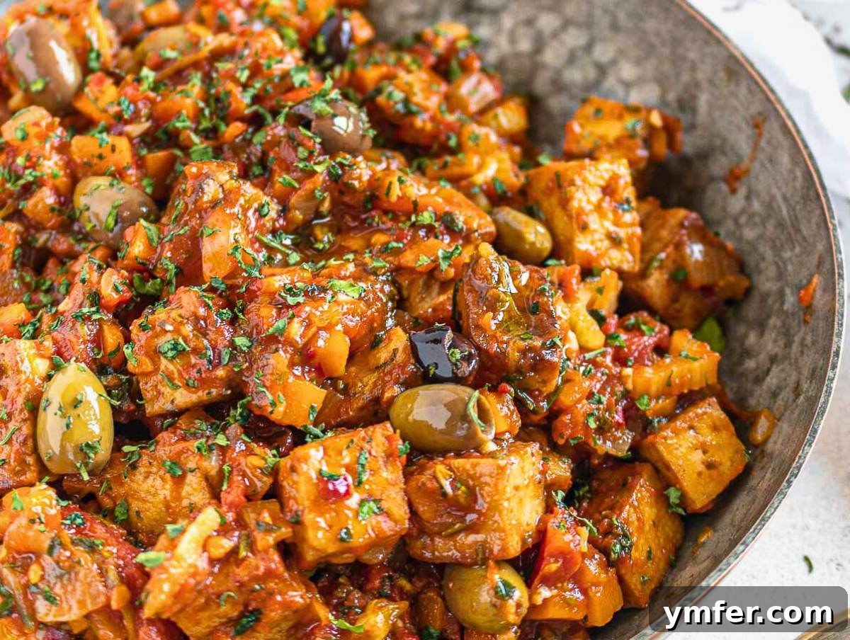The Forager's Tofu Cacciatore 3 Freshly cooked tofu cacciatore garnished with vibrant Italian herbs, ready to be served.
