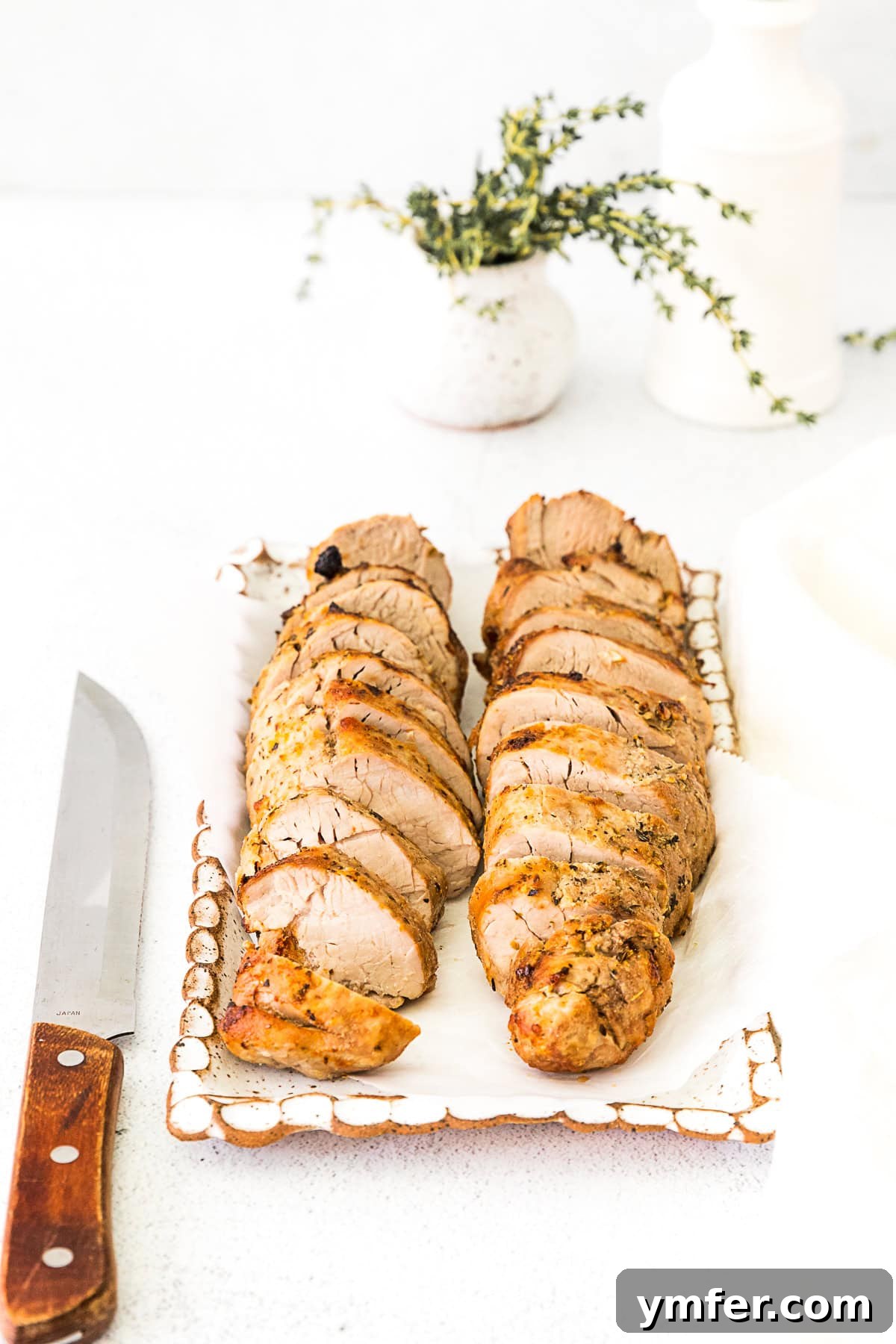 Perfect Air Fryer Pork Tenderloin 7 Air Fryer Pork Tenderloin beautifully presented on a white plate, ready to serve.
