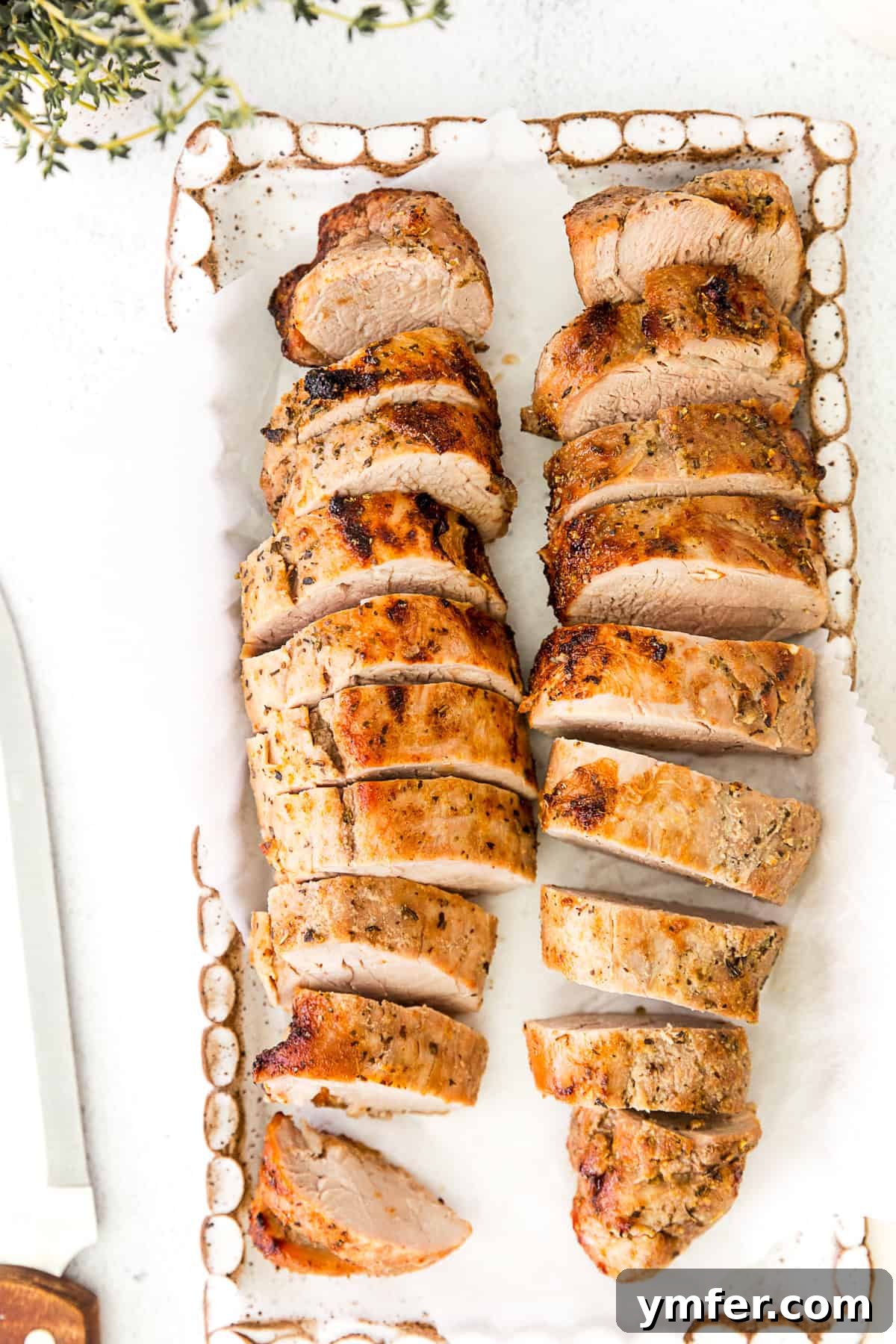 Perfect Air Fryer Pork Tenderloin 8 Air Fryer Pork Tenderloin cooked and presented on a serving platter, ready for carving.