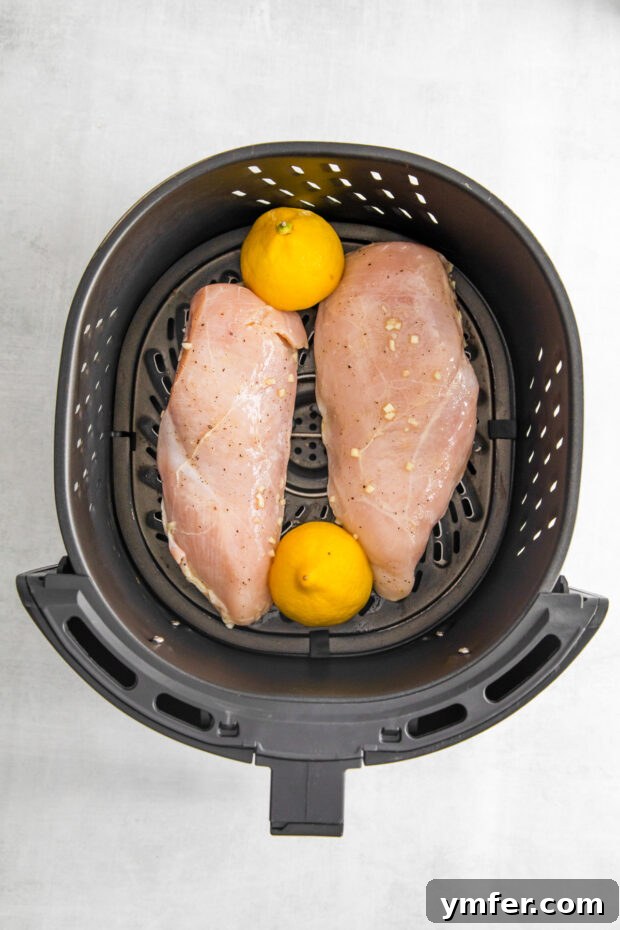 Crispy Zesty Air Fryer Lemon Chicken 5 Uncooked Air Fryer Lemon Chicken in the air fryer basket.