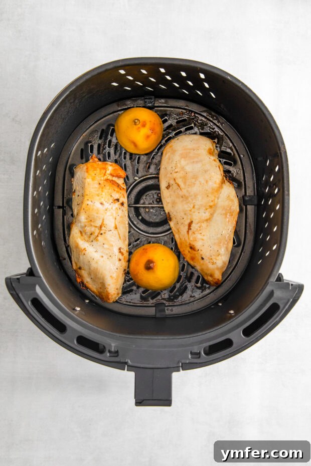 Crispy Zesty Air Fryer Lemon Chicken 6 Cooked Air Fryer Lemon Chicken in the air fryer basket.