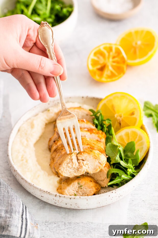 Crispy Zesty Air Fryer Lemon Chicken 7 A fork picking up a slice of Air Fryer Lemon Chicken.