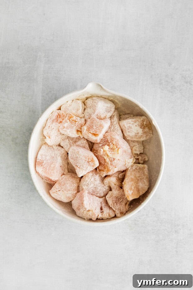 Sticky Honey Garlic Chicken Bowls 4 Cubed chicken breast tossed in flour, ready to be cooked.