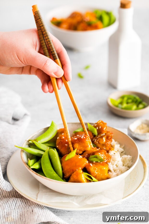 Sticky Honey Garlic Chicken Bowls 7 Honey Garlic Chicken Bowls served with chopsticks, ready to be enjoyed.