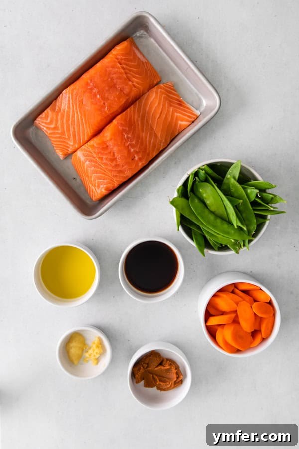 Air Fried Miso-Glazed Salmon 3 All ingredients for Air Fryer Miso Salmon laid out on a wooden table, ready for preparation.