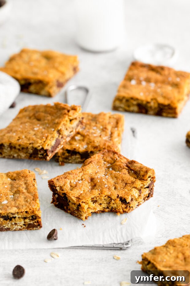 Ultimate Chocolate Chunk Oatmeal Bars 6 Close-up of freshly baked Chocolate Chunk Oatmeal Cookie Bars, generously sprinkled with flakey sea salt.