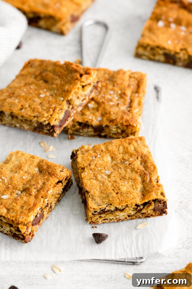 Ultimate Chocolate Chunk Oatmeal Bars 8 Perfectly sliced Chocolate Chunk Oatmeal Cookie Bars arranged on a table, ready to be served.