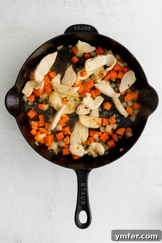 Savory Cashew Chicken Pad Thai 6 Chicken and carrots in a skillet.