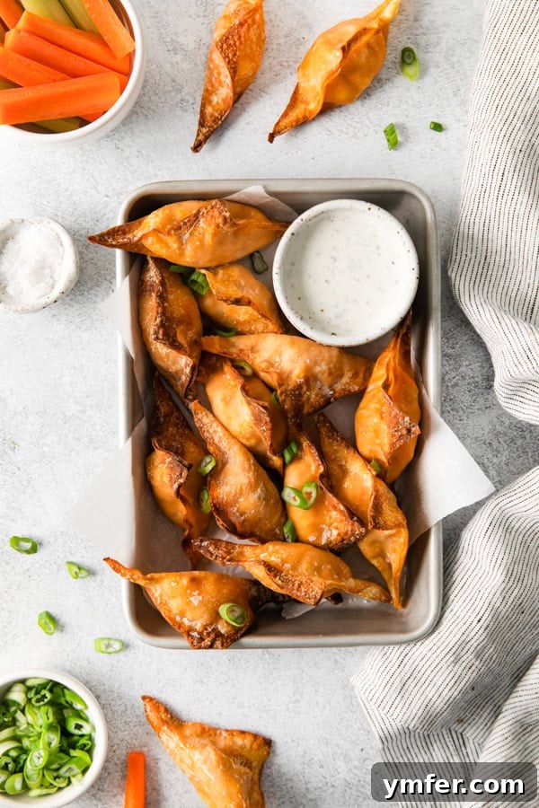 Crispy Air Fried Buffalo Wonton Poppers 2 Air Fryer Buffalo Chicken Wontons on a serving tray with dip.