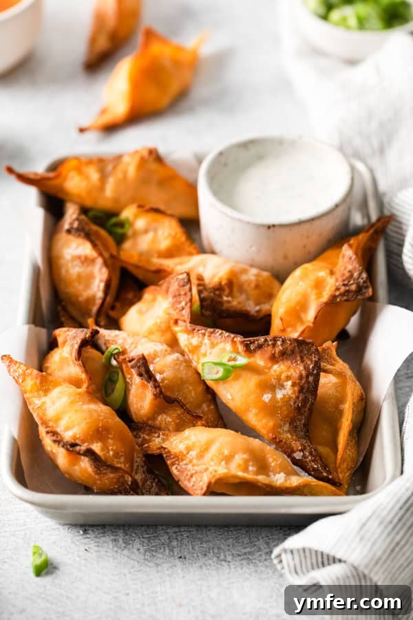 Crispy Air Fried Buffalo Wonton Poppers 8 Air Fryer Buffalo Chicken Wontons in a tray for serving.