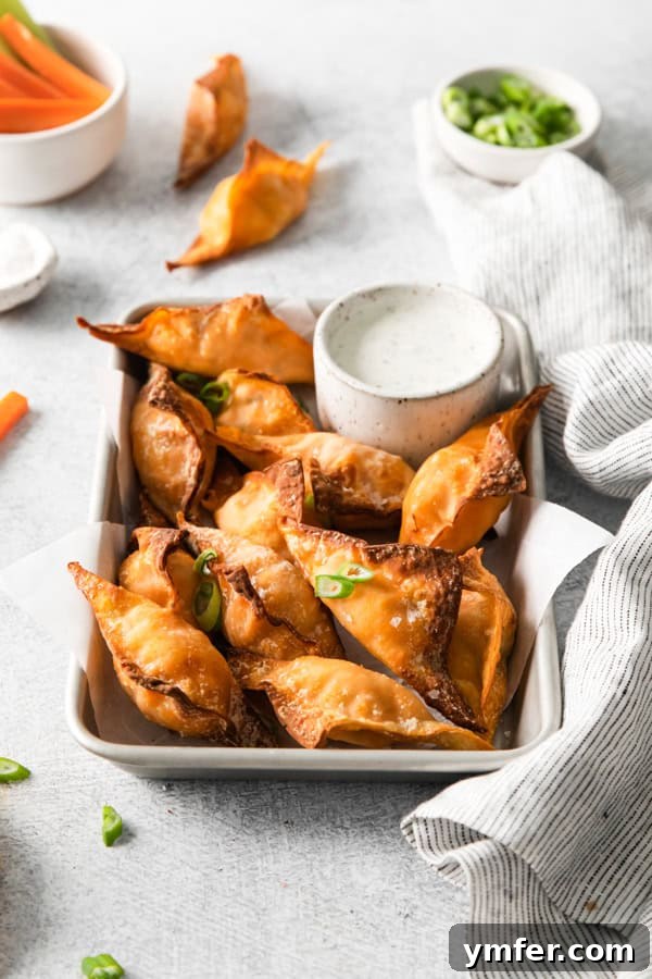 Crispy Air Fried Buffalo Wonton Poppers 6 Air Fryer Buffalo Chicken Wontons topped with green onions.