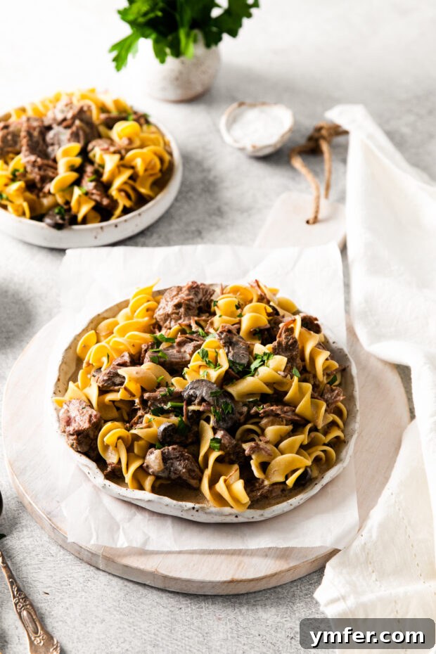 Hearty Creamy Slow Cooker Beef Stroganoff 4 Slow Cooker Beef Stroganoff served with egg noodles.
