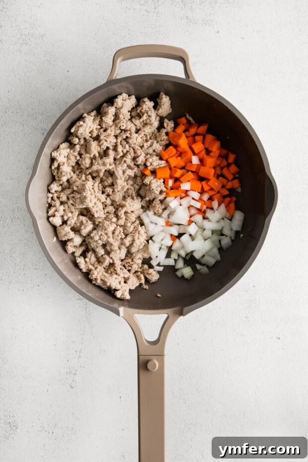 Umami Chicken Ramen Stir Fry 4 Ground chicken and vegetables in a skillet.