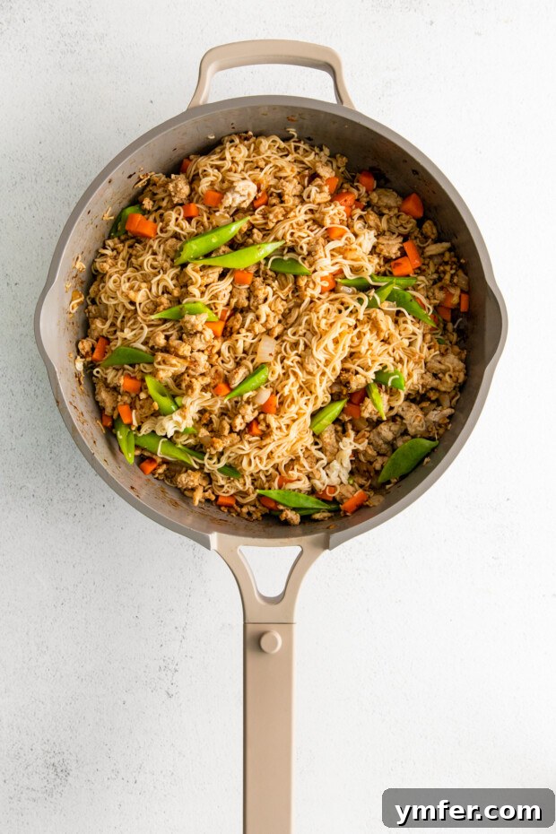 Umami Chicken Ramen Stir Fry 6 Ground Chicken Ramen Stir Fry in a skillet.