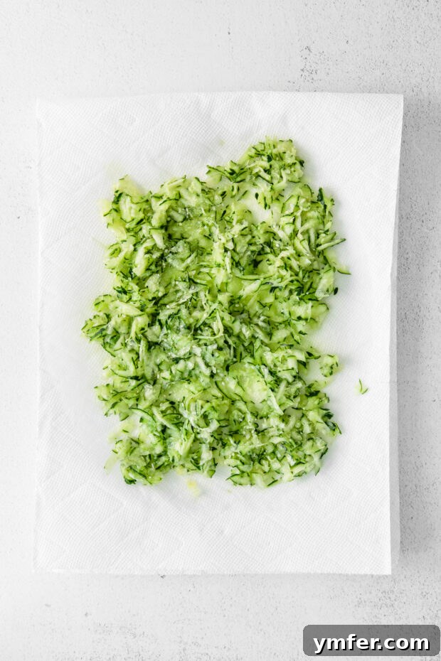 Refreshing Cucumber Yogurt Dip 4 Shredded cucumbers draining on a paper towel, a crucial step for preventing watery Tzatziki.