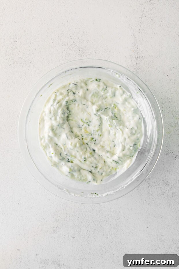 Refreshing Cucumber Yogurt Dip 6 A bowl of freshly mixed Tzatziki sauce, ready to be chilled and served.