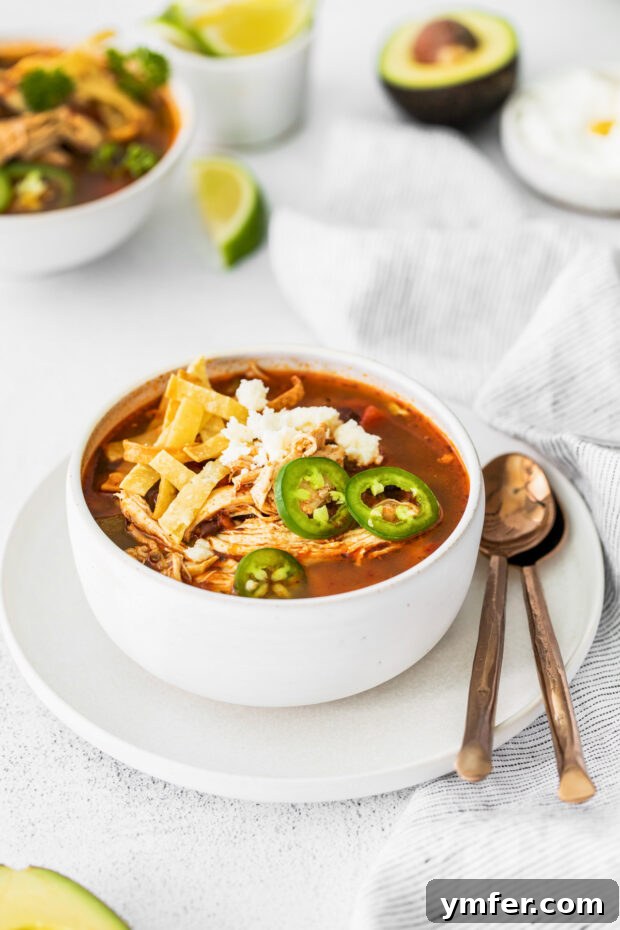 Zesty Instant Pot Chicken Tortilla Soup 4 A serving of Instant Pot Chicken Tortilla Soup garnished with fresh jalapeno slices for an extra kick.