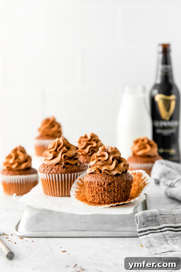 Velvet Stout Chocolate Cupcakes 2 Beautifully frosted Chocolate Guinness Cupcakes arranged on a table, ready to be enjoyed.
