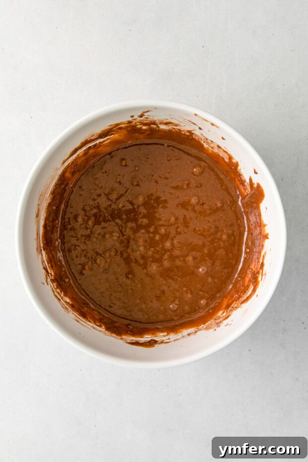 Velvet Stout Chocolate Cupcakes 4 Smooth, dark chocolate cupcake batter swirled in a mixing bowl, ready for baking.
