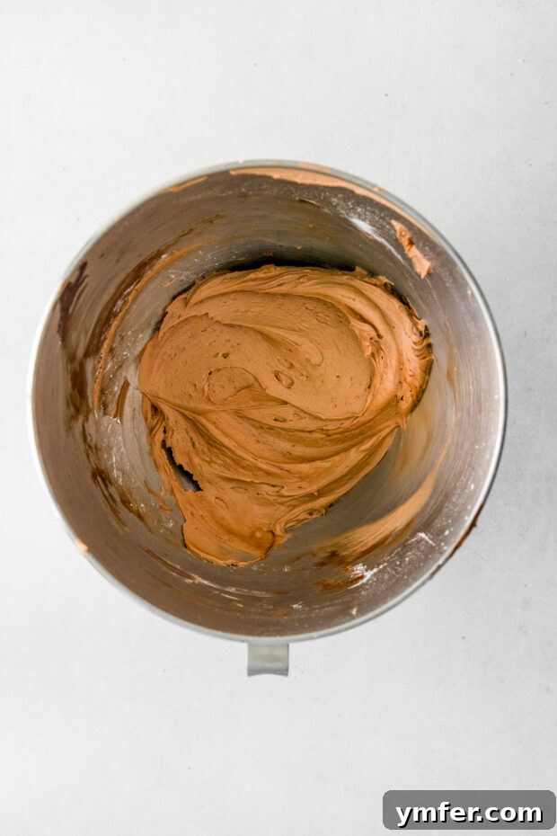 Velvet Stout Chocolate Cupcakes 6 Luxurious chocolate frosting being whipped to perfection in a mixing bowl.