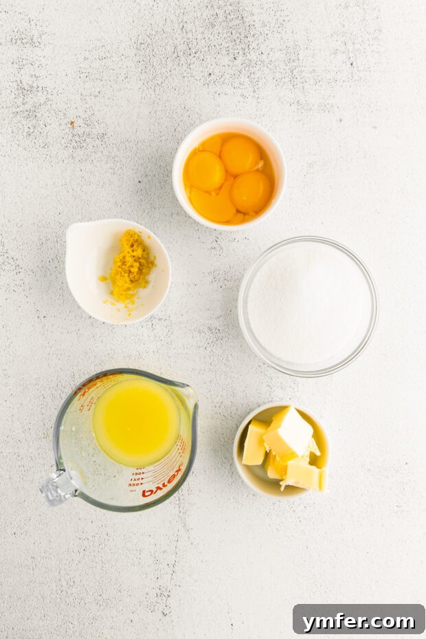 Cloud-Kissed Lemon Tartlets 5 Vibrant yellow ingredients for the luscious lemon curd, including fresh lemons, eggs, sugar, and butter, neatly arranged.