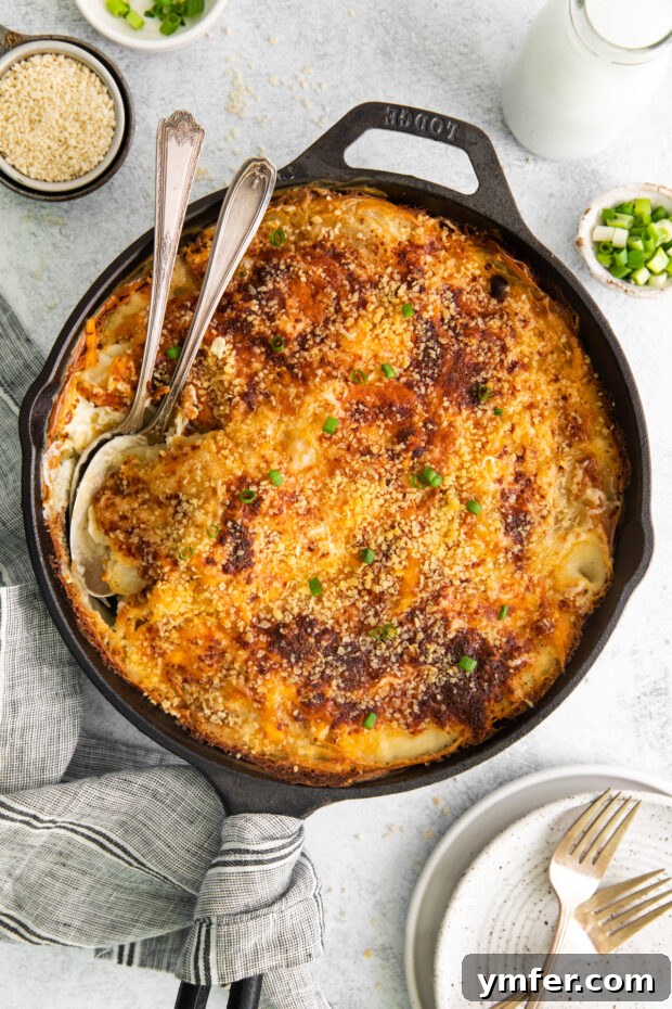 Ultimate Homemade Scalloped Potatoes 2 Homemade Scalloped Potatoes in a cast iron skillet, golden brown and bubbly.