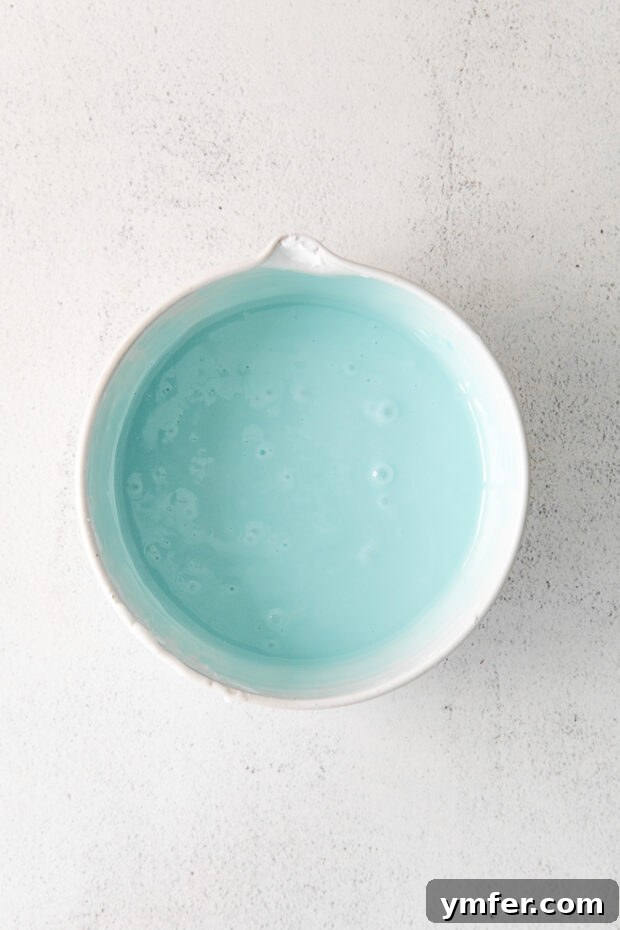Robin's Egg Blue Baked Donuts 4 A bowl of vibrant blue glaze for donuts, ready for dipping.