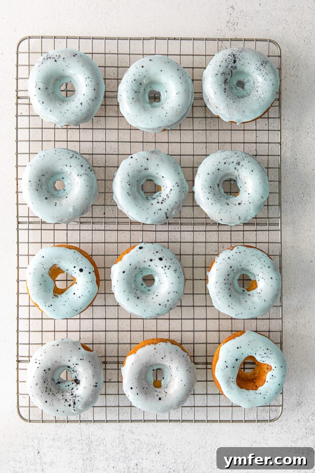 Robin's Egg Blue Baked Donuts 6 Robin's Egg Baked Donuts with blue glaze and speckles, arranged neatly on a cooling rack.