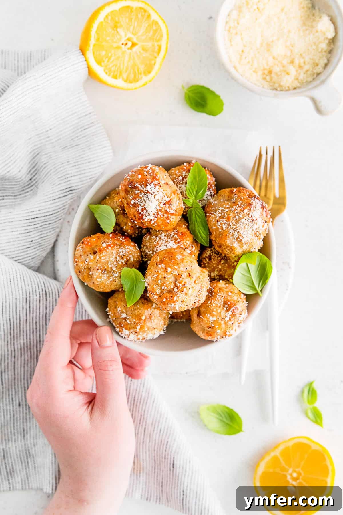 Crispy Air Fryer Chicken Meatballs 9 A bowl of Air Fryer Chicken Meatballs served with a generous sprinkle of parmesan cheese, ready to eat.