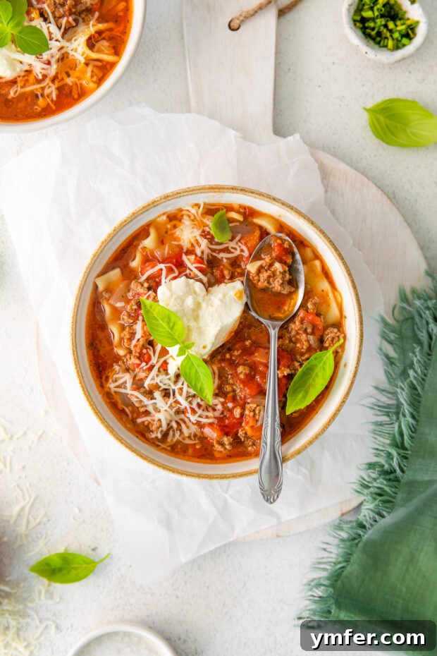 Easy Instant Pot Lasagna Soup 2 Instant Pot Lasagna Soup in a bowl with a spoon, garnished with fresh herbs and cheese.
