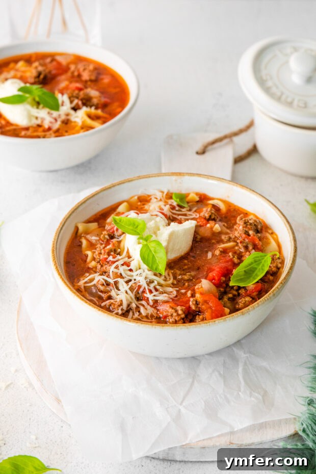 Easy Instant Pot Lasagna Soup 7 Instant Pot Lasagna Soup served in a bowl, generously topped with shredded cheese.