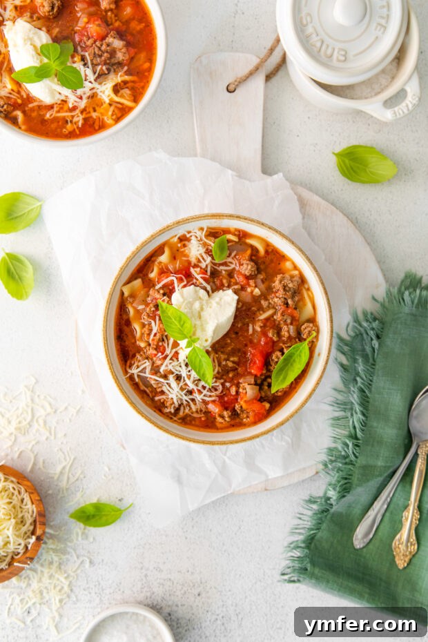 Easy Instant Pot Lasagna Soup 8 A bowl of Instant Pot Lasagna Soup garnished with fresh basil leaves.
