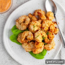 A plate of perfectly cooked crispy air fryer shrimp.