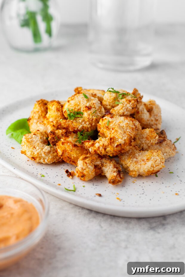 Golden Crispy Air Fryer Shrimp 9 Crispy Air Fryer Shrimp artfully arranged on a plate, ready to be enjoyed.