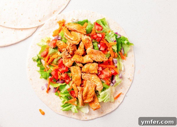 Zesty Buffalo Chicken Wrap 4 An open Buffalo Chicken Wrap showing all the fresh ingredients before being rolled.