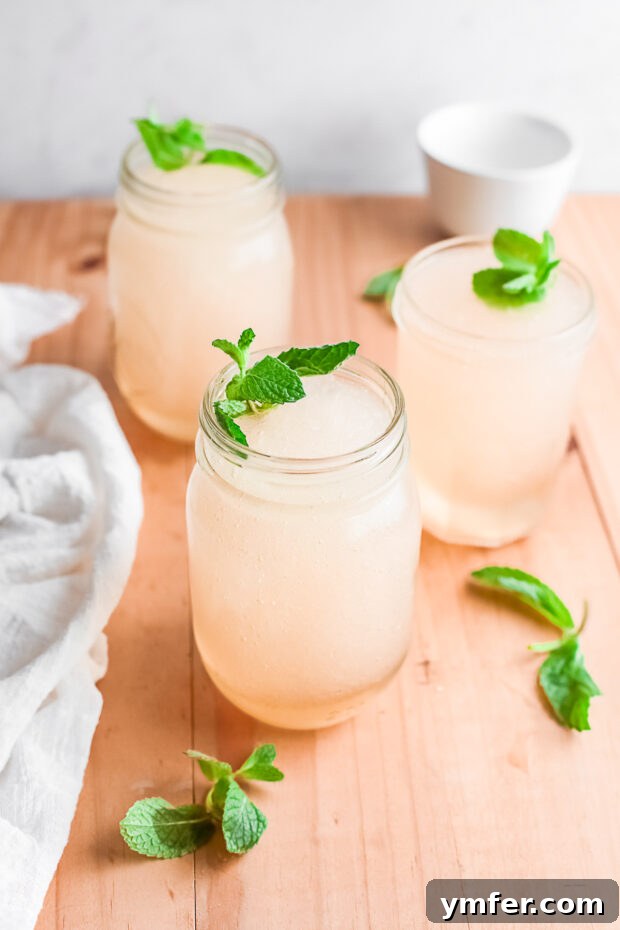 Kentucky Mint Slush 8 A refreshing Frozen Mint Julep served in a rustic mason jar, garnished with a generous sprig of fresh mint.