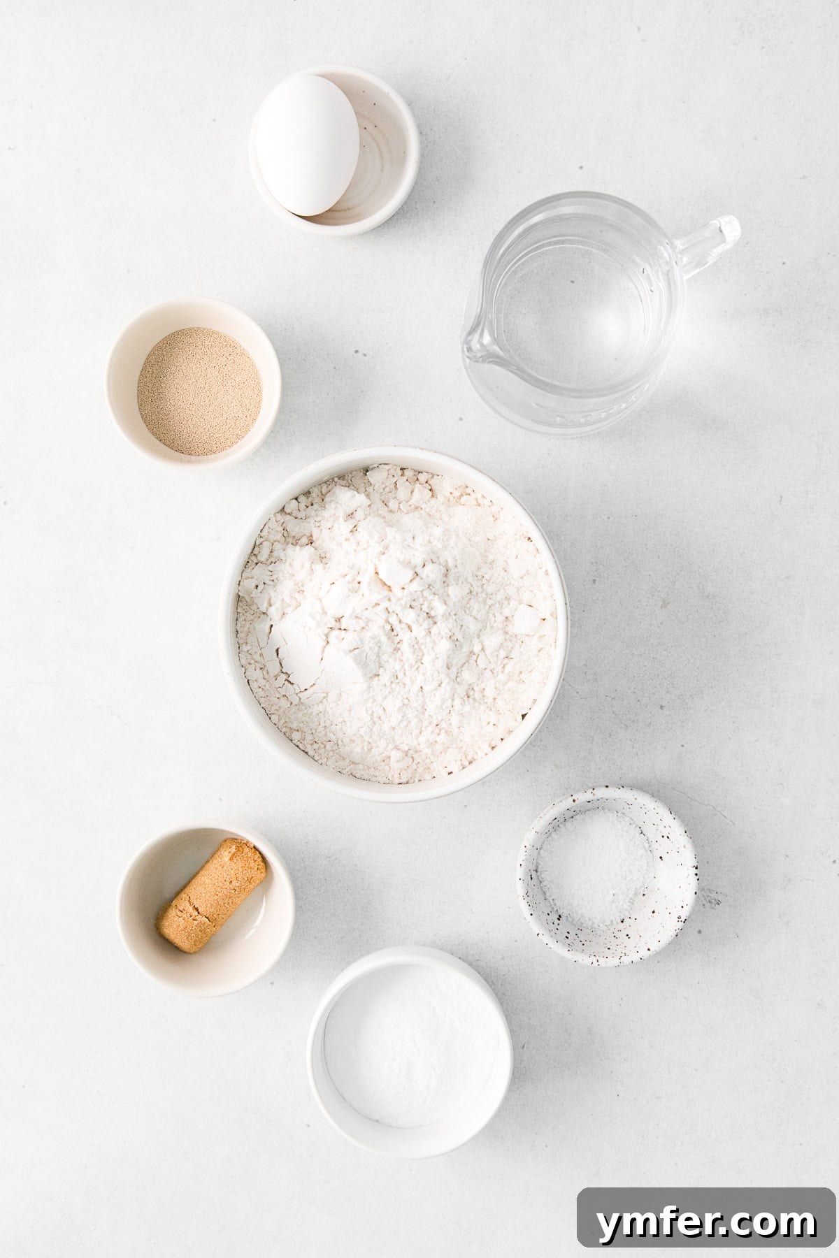 A collection of fresh ingredients laid out on a clean surface, ready for making homemade soft pretzels.