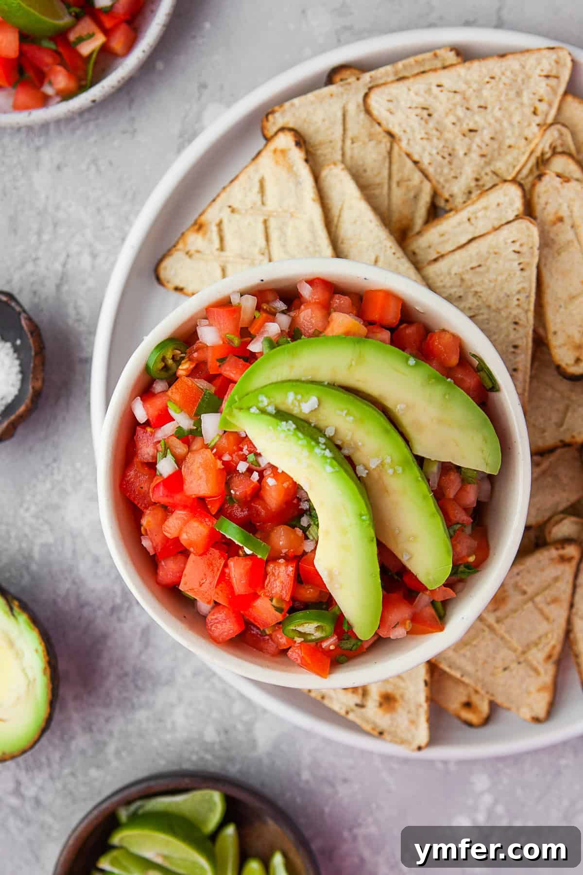 Vibrant Mexican Salsa 2 Pico de Gallo in a bowl topped with avocado.