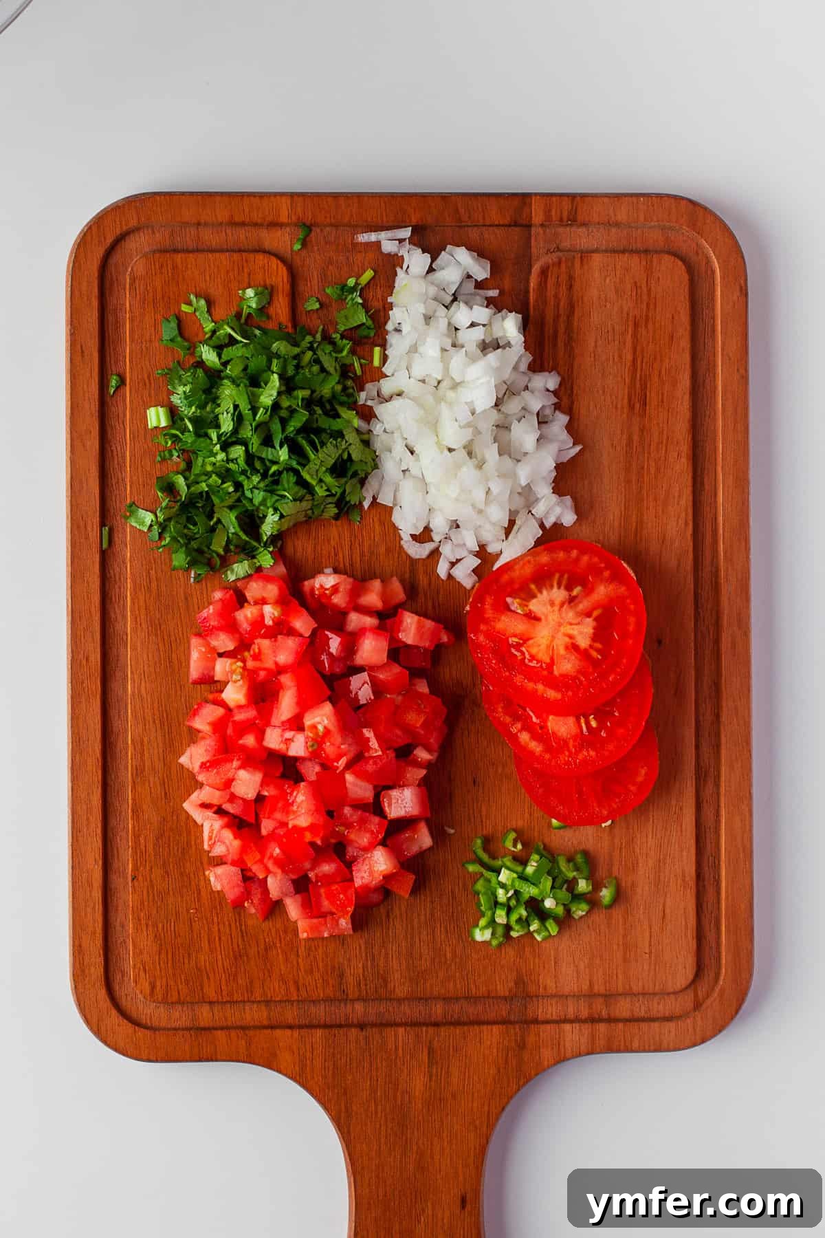 Vibrant Mexican Salsa 4 Chopped tomatoes, cilantro, onion, and chilies on a cutting board.