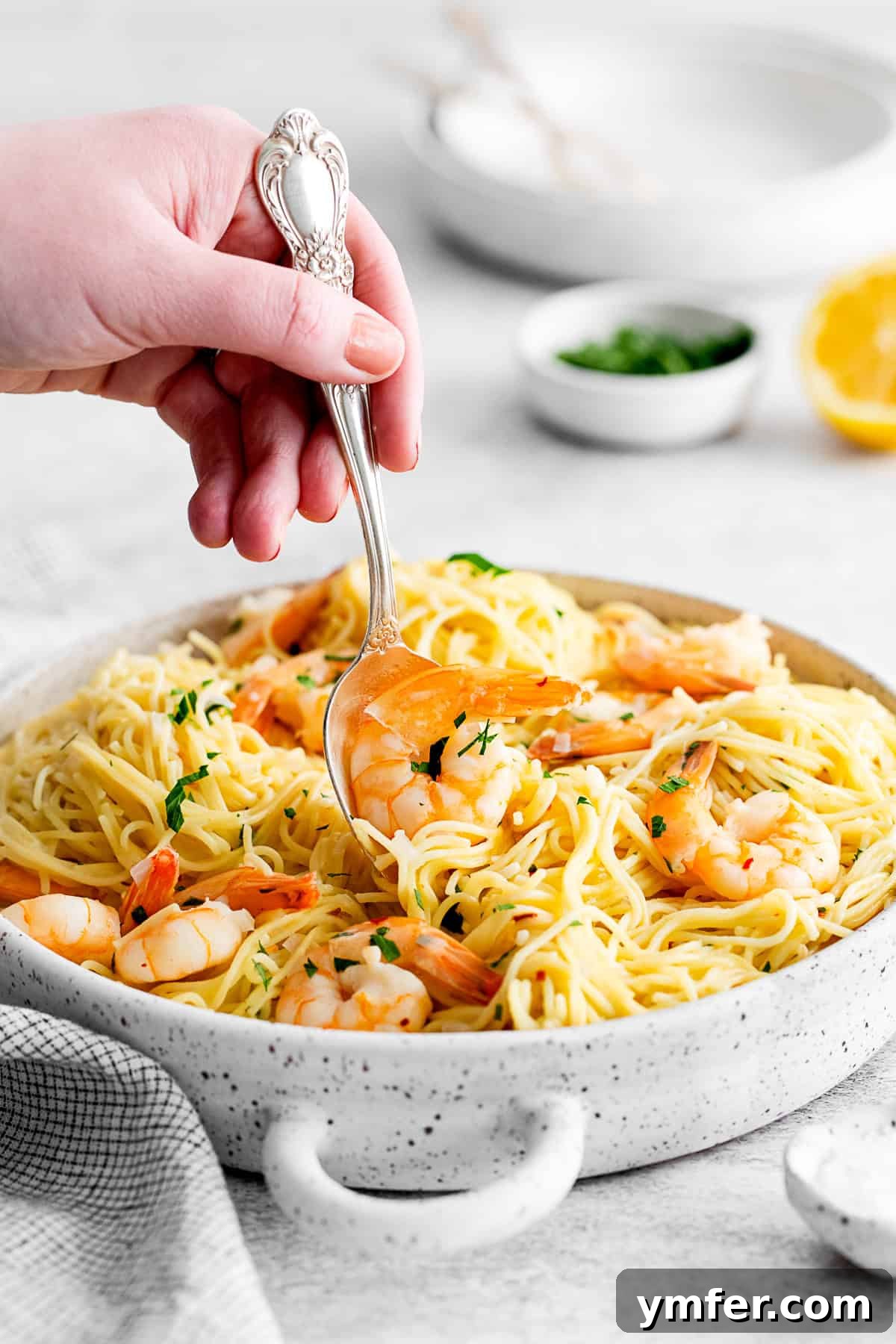 Effortless Instant Pot Shrimp Scampi 10 A spoon picking up a shrimp out of shrimp scampi.