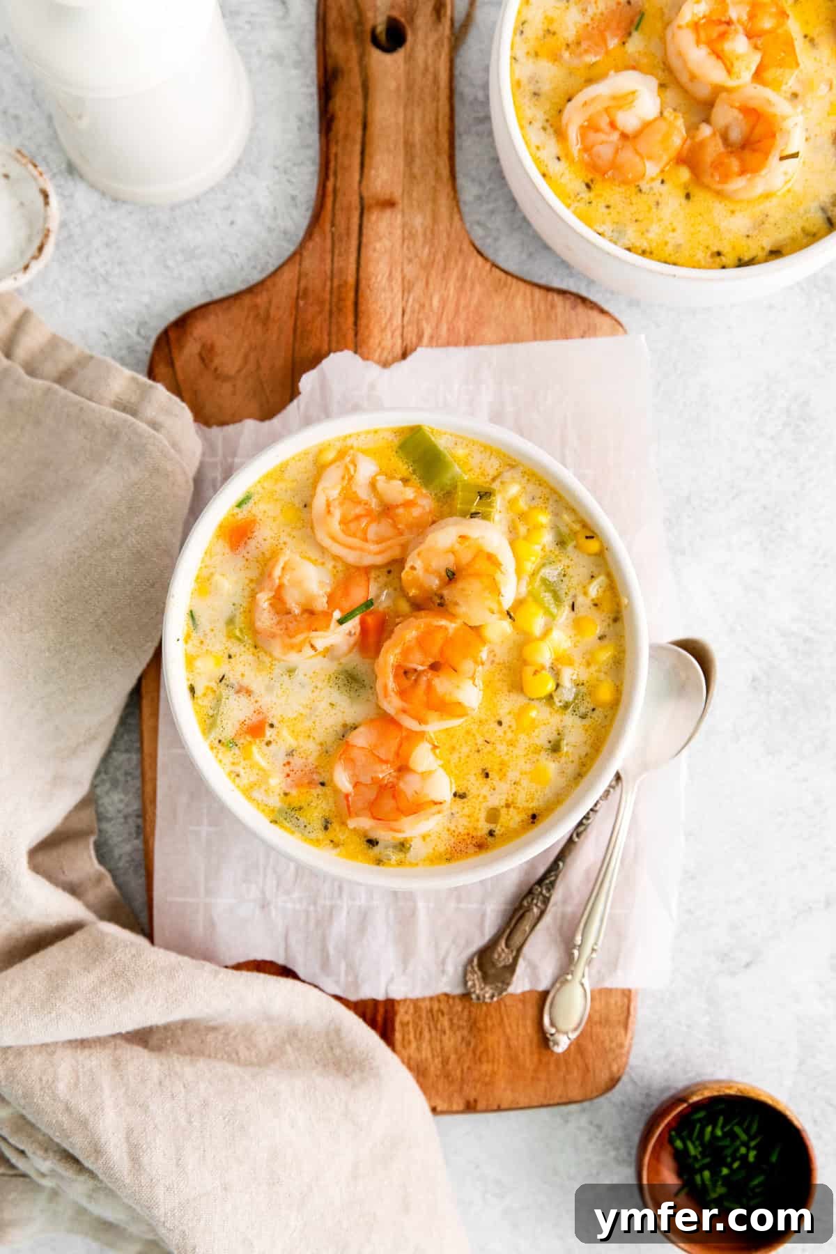 Golden Harvest Shrimp and Corn Chowder 2 A generously filled bowl of creamy Shrimp Corn Chowder, garnished with fresh herbs.